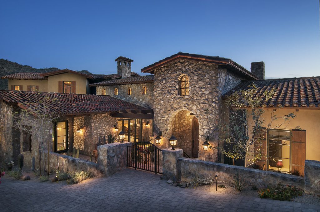 Stone entry and illuminated windows at Silverleaf Hideaway at dusk