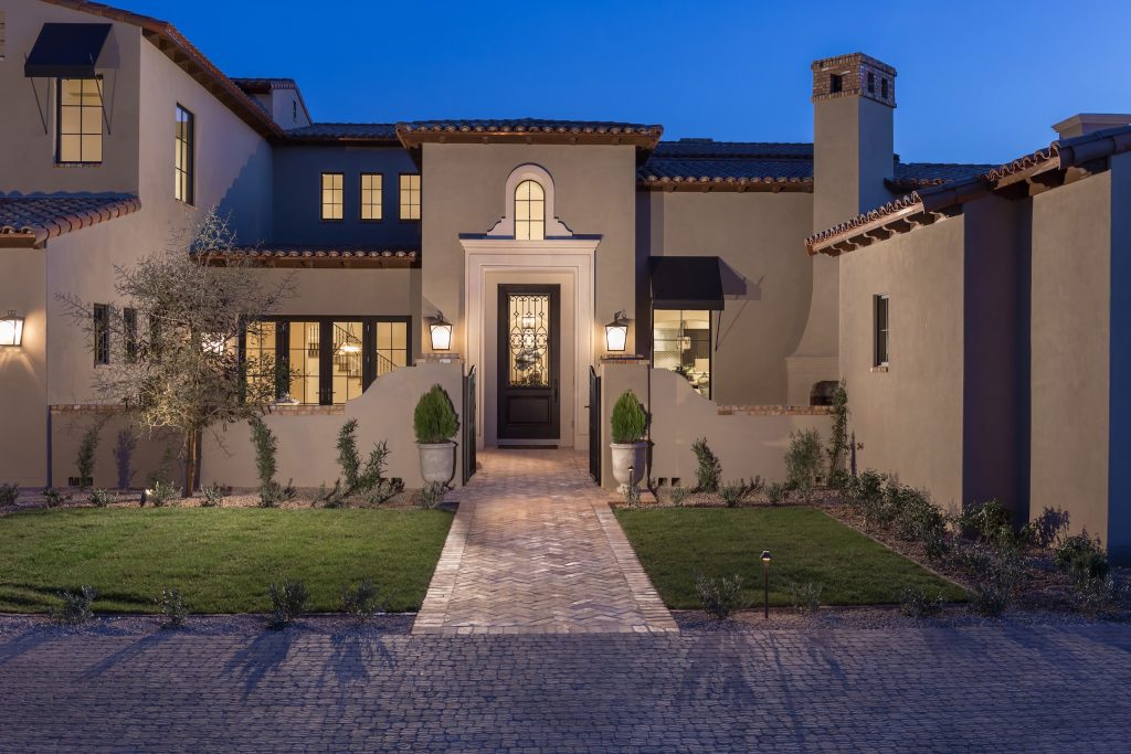 Front courtyard and illuminated entry at Andalusian Modern by Calvis Wyant