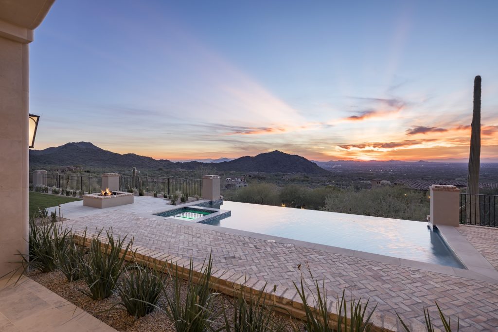Infinity-edge pool and sunset desert view at Andalusian Modern