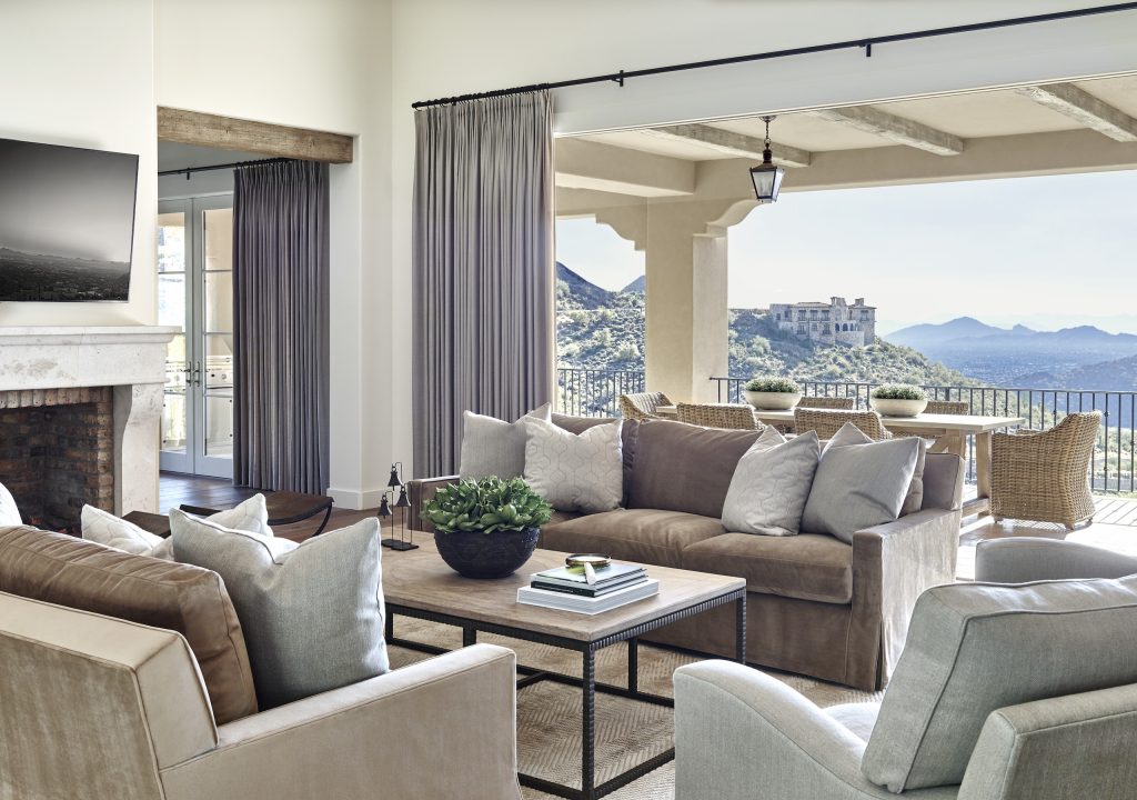Summit Vista living room opening to a covered terrace and mountain views