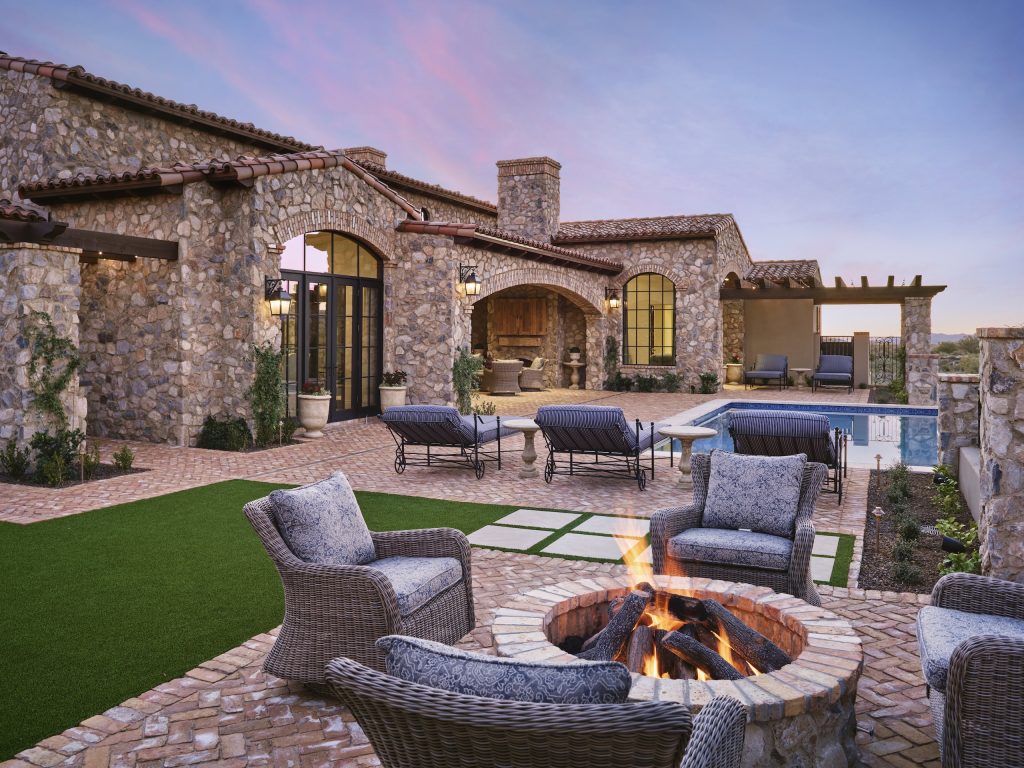 Stone courtyard, pool, and fire feature at Mirabel Retreat